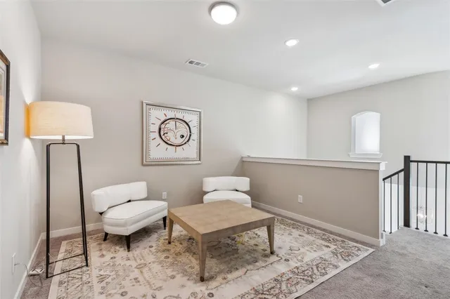 a living room with furniture and a rug