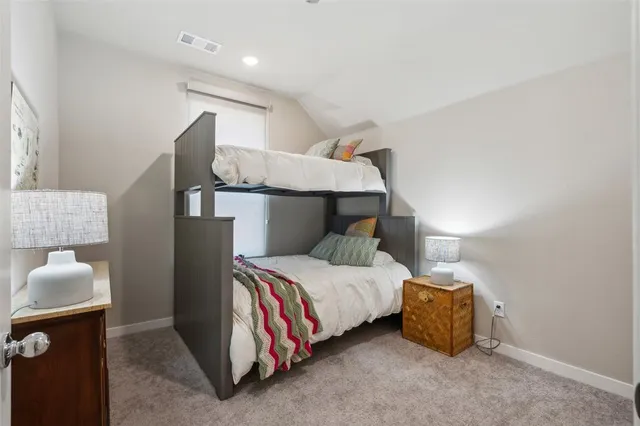 a bedroom with a bed and a lamp