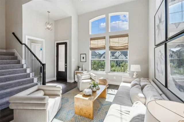 a living room with furniture and a large window with outer view