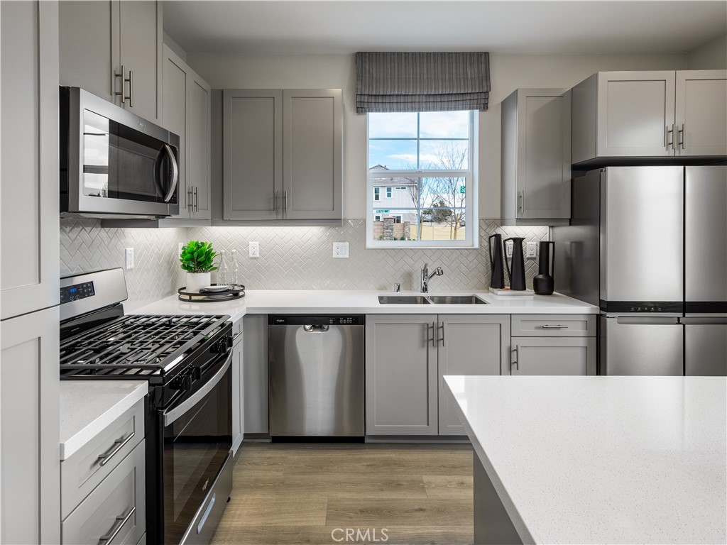 10208 Calder Circle Riverside, CA 92503 - Photo 1 of 1 a kitchen with white cabinets and appliances