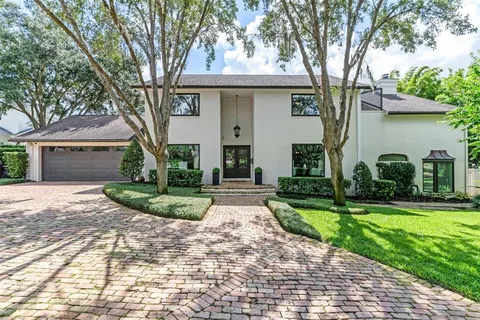 a front view of a house with a yard and a garage