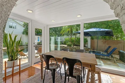 a living room with furniture a chandelier and a window