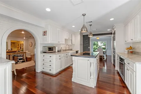 a living room with furniture a rug and a chandelier