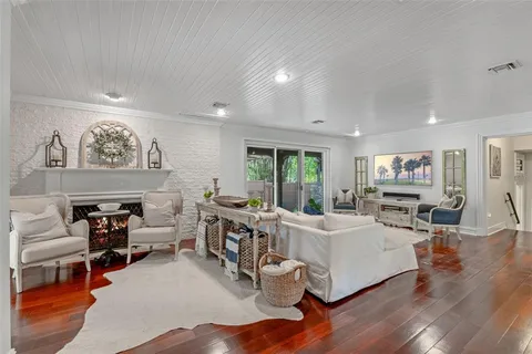 a room with furniture a rug and a large window