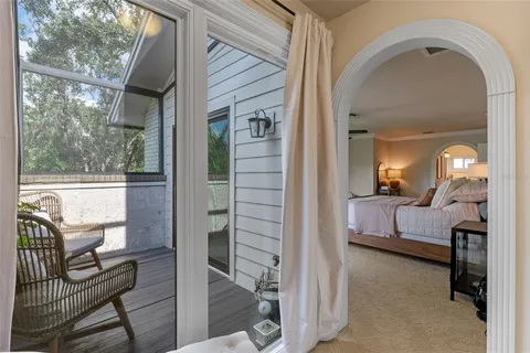 a bedroom with a large bed a chandelier and dresser