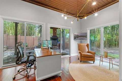a living room with a large window and book shelf
