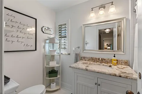 a view of a house with backyard sitting area and garden