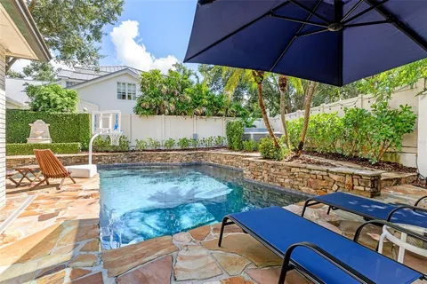 a view of a patio with a dining table and chairs with wooden floor