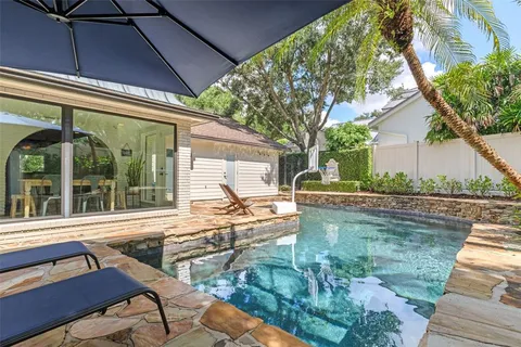 an aerial view of a house with a yard and garden