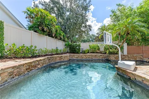 an aerial view of a house with outdoor space and lake view