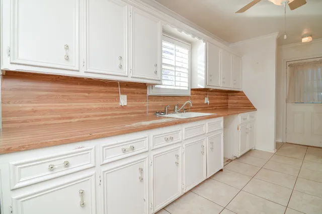 a kitchen with stainless steel appliances granite countertop white cabinets and window