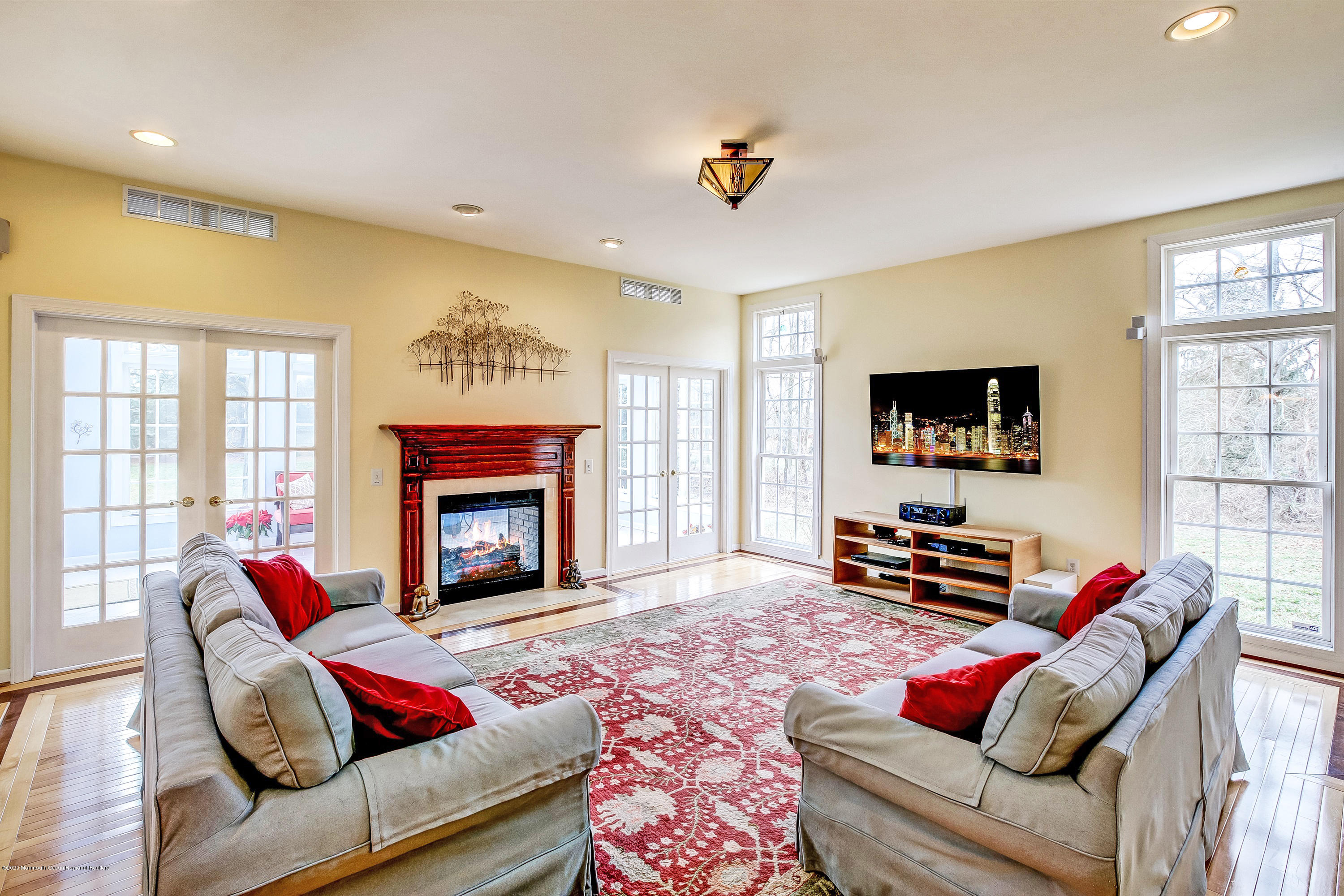 2801 Colonial Drive Wall, NJ 07719 - Photo 13 of 43 a living room with furniture a flat screen tv and a fireplace