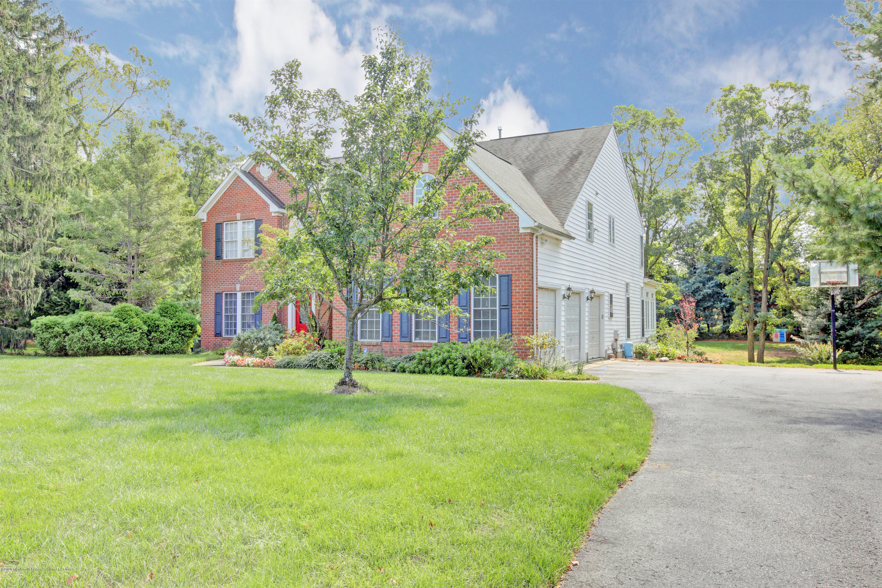 2801 Colonial Drive Wall, NJ 07719 - Photo 2 of 43 a front view of a house with a yard and garage
