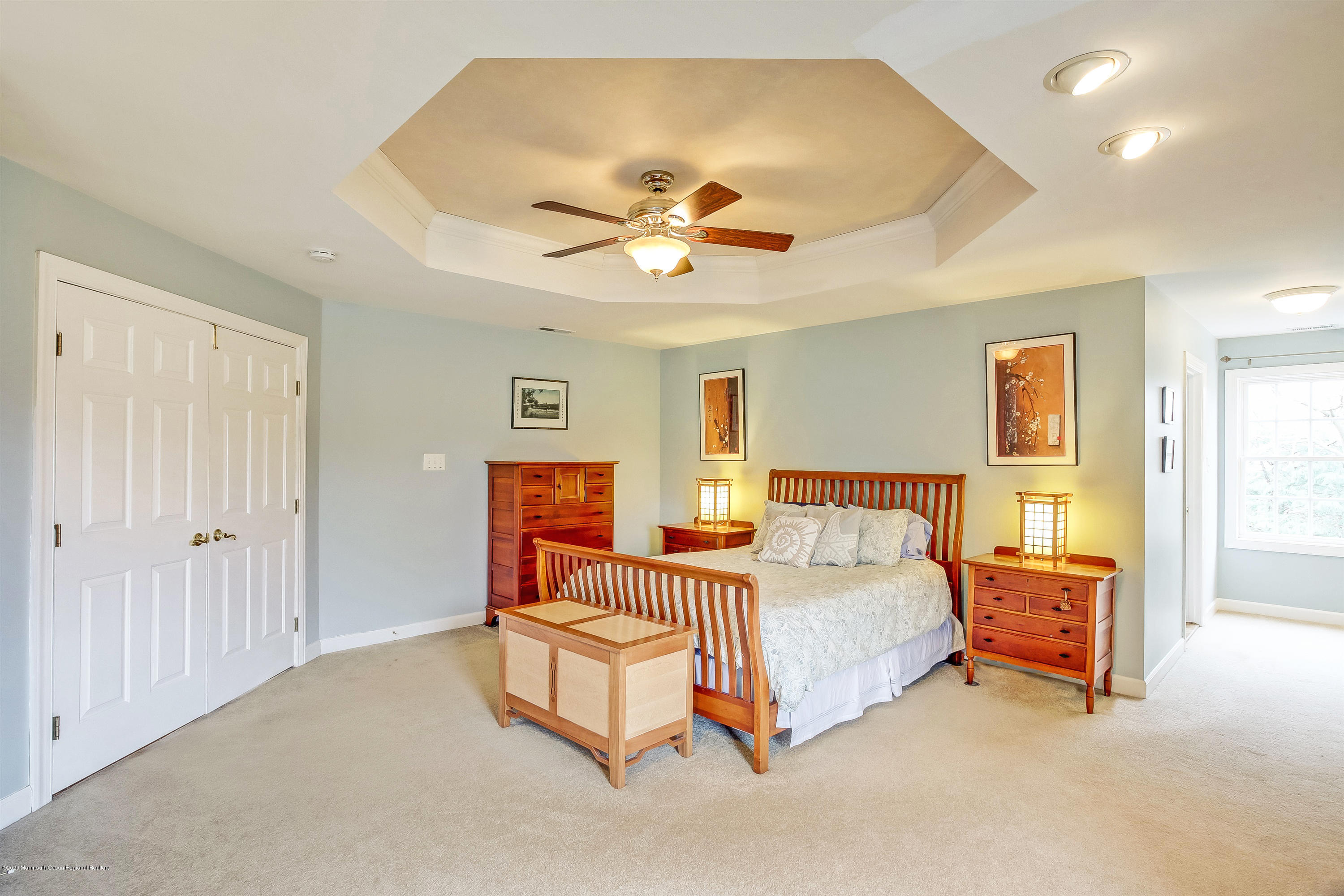 2801 Colonial Drive Wall, NJ 07719 - Photo 22 of 43 a bedroom with a bed and a chandelier