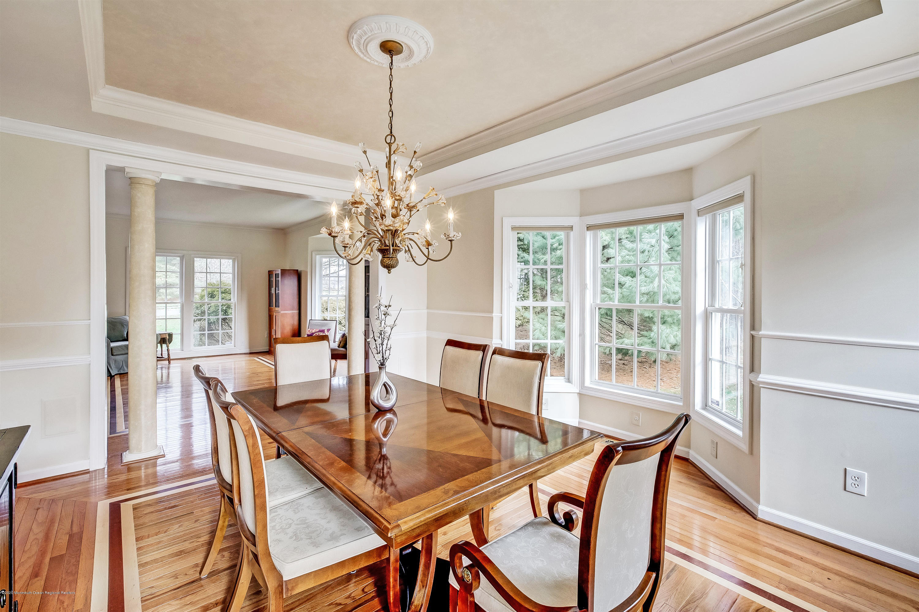 2801 Colonial Drive Wall, NJ 07719 - Photo 8 of 43 a dining room with furniture a chandelier and wooden floor