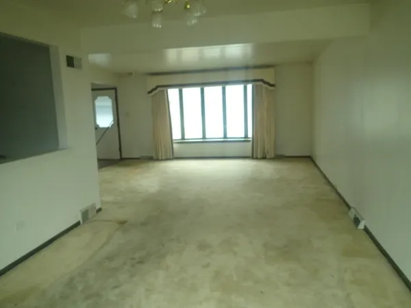 an empty room with windows and entrance