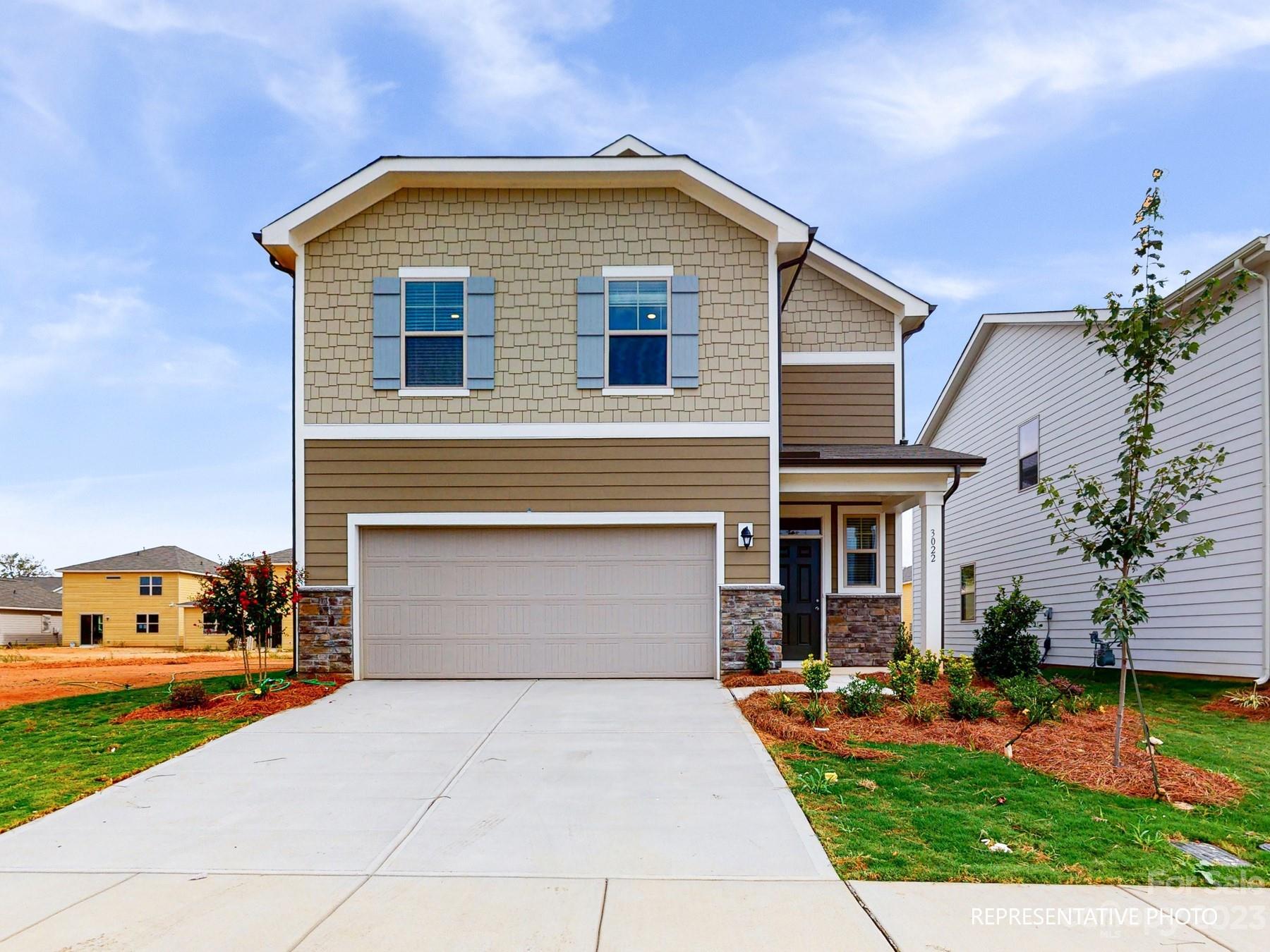 5028 Raspberry Knoll Drive, Unit 1 Charlotte, NC 28208 - Photo 1 of 16 a front view of a house with a yard