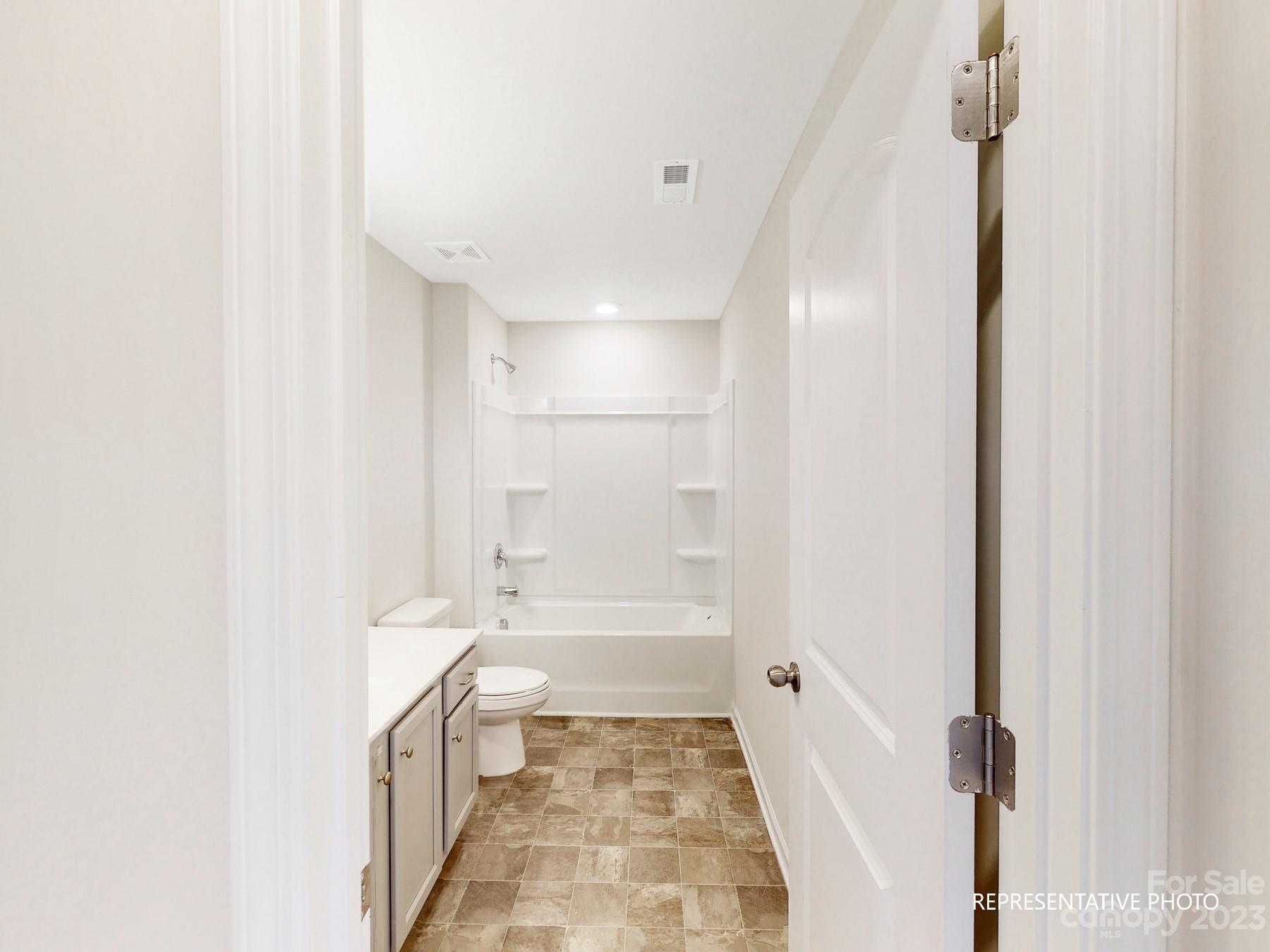 5028 Raspberry Knoll Drive, Unit 1 Charlotte, NC 28208 - Photo 13 of 16 a bathroom with a bathtub and a shower