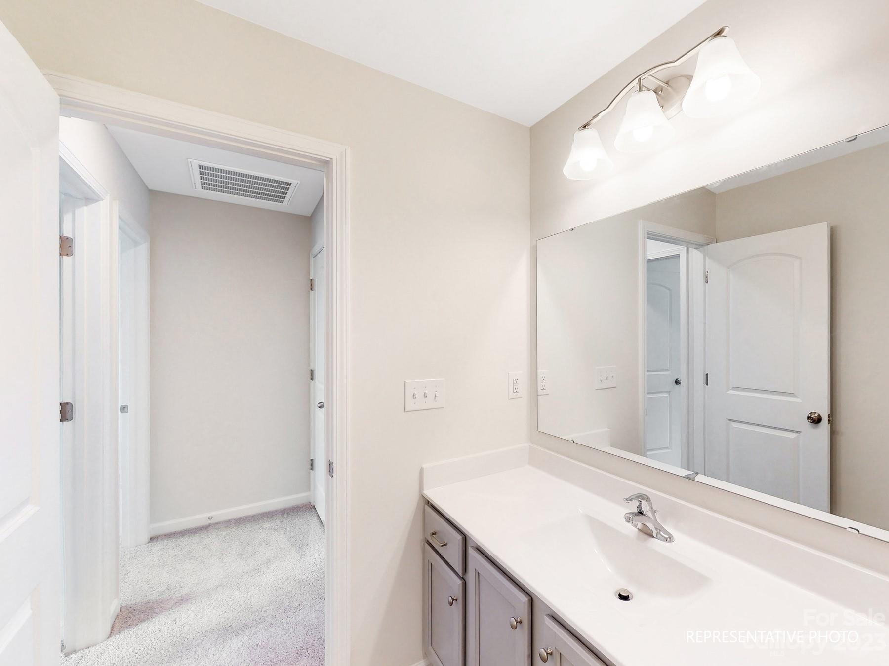 5028 Raspberry Knoll Drive, Unit 1 Charlotte, NC 28208 - Photo 14 of 16 a bathroom with a sink and a mirror