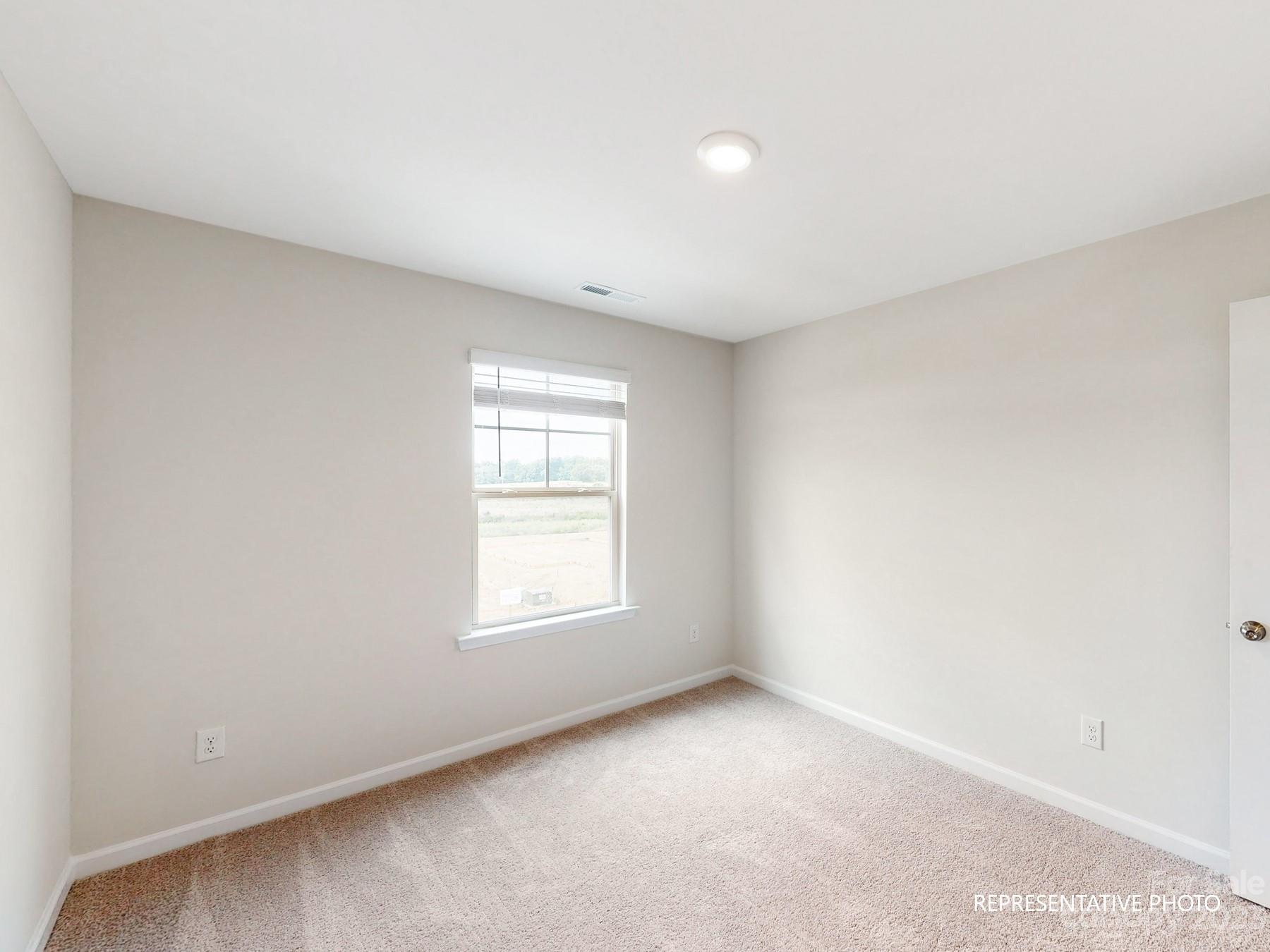 5028 Raspberry Knoll Drive, Unit 1 Charlotte, NC 28208 - Photo 15 of 16 an empty room with a window