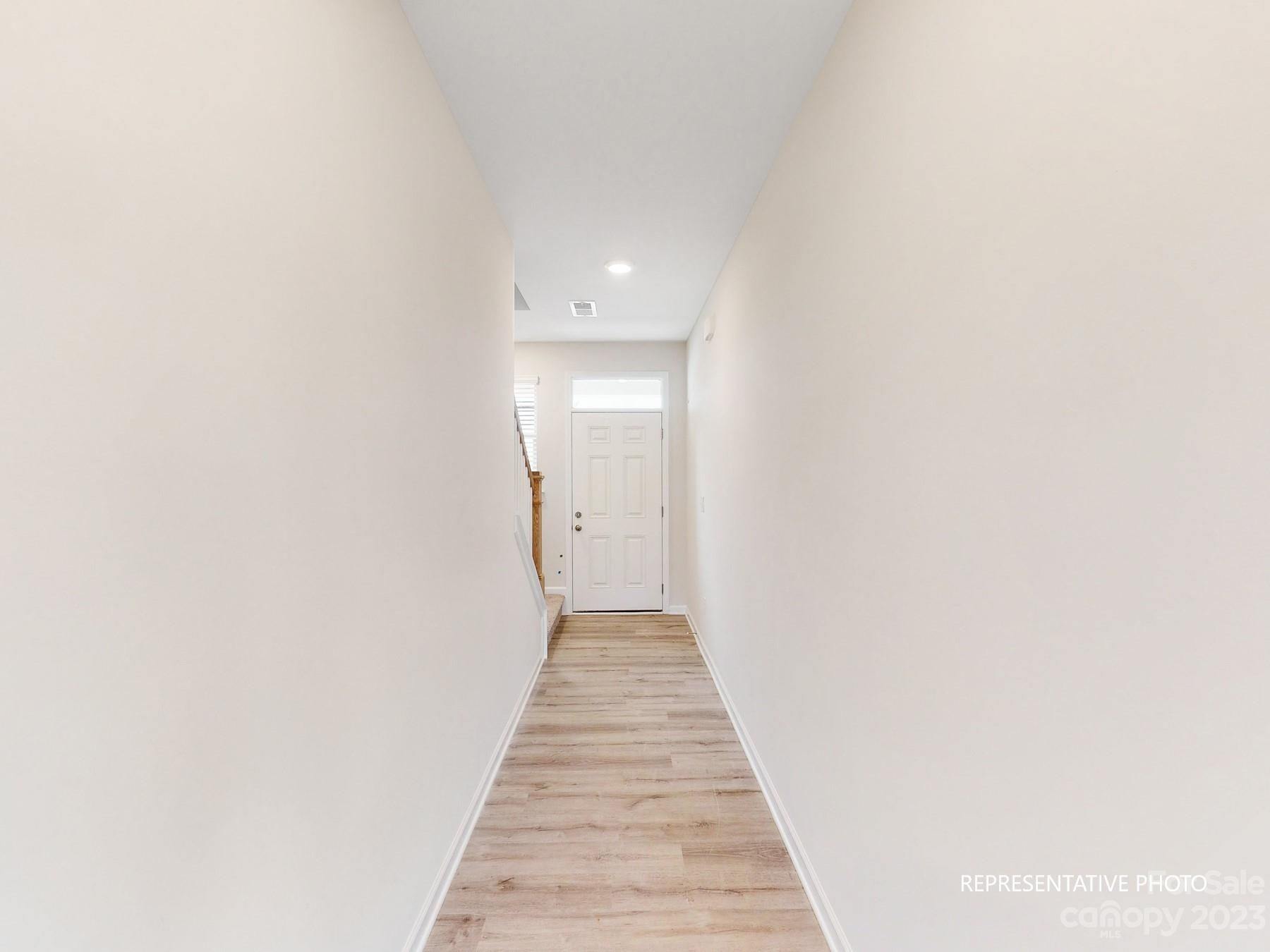 5028 Raspberry Knoll Drive, Unit 1 Charlotte, NC 28208 - Photo 6 of 16 a view of a hallway with wooden floor