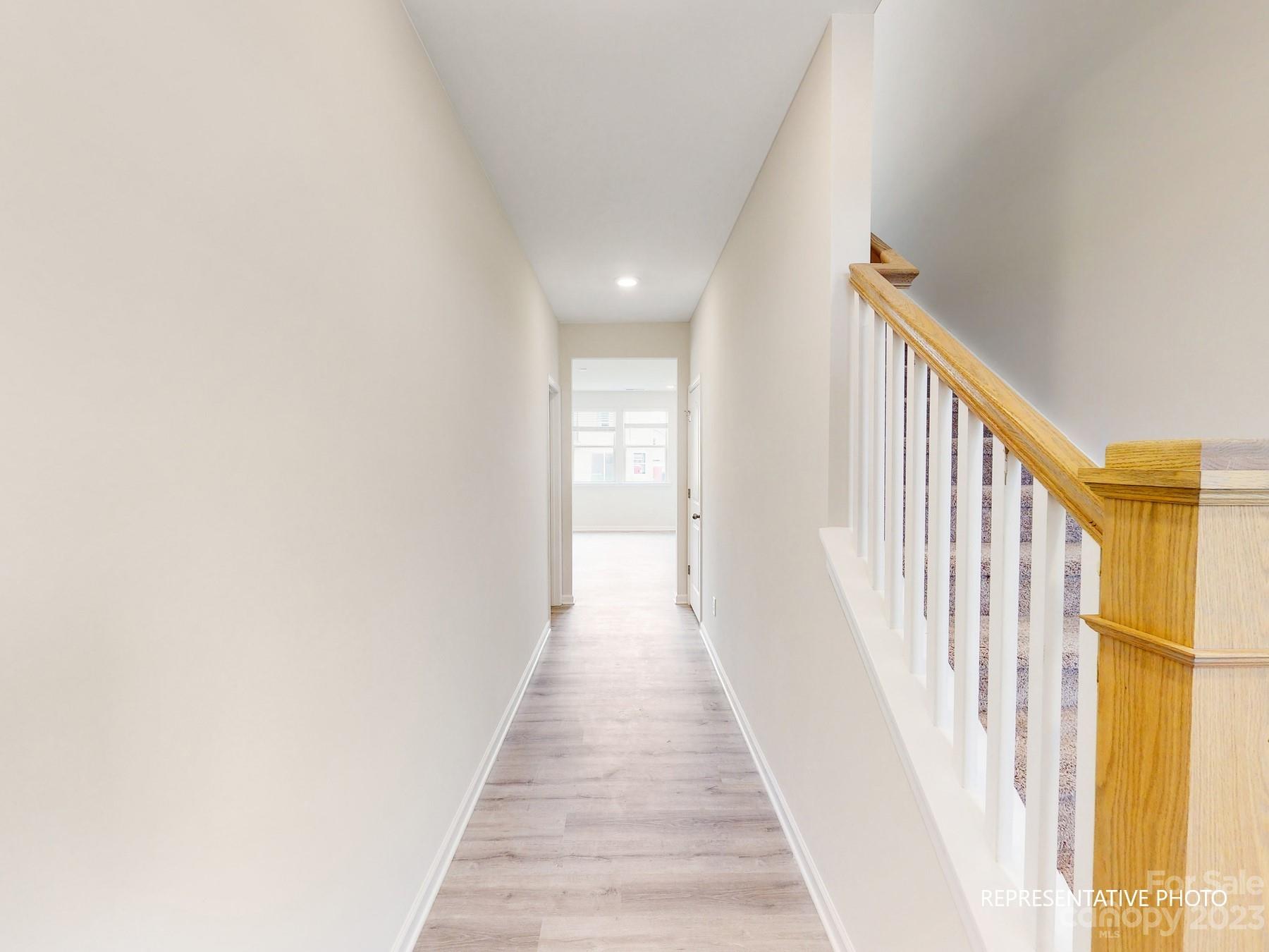 5028 Raspberry Knoll Drive, Unit 1 Charlotte, NC 28208 - Photo 8 of 16 a view of a hallway with wooden floor and staircase