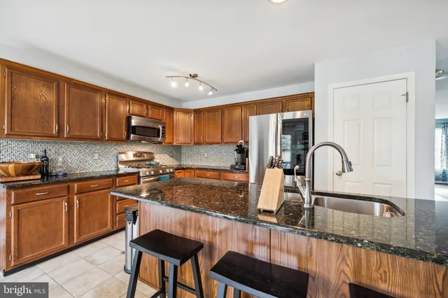 a kitchen with granite countertop a sink and cabinets