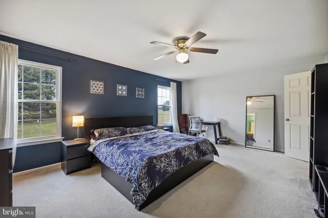 a bedroom with a large bed and a window