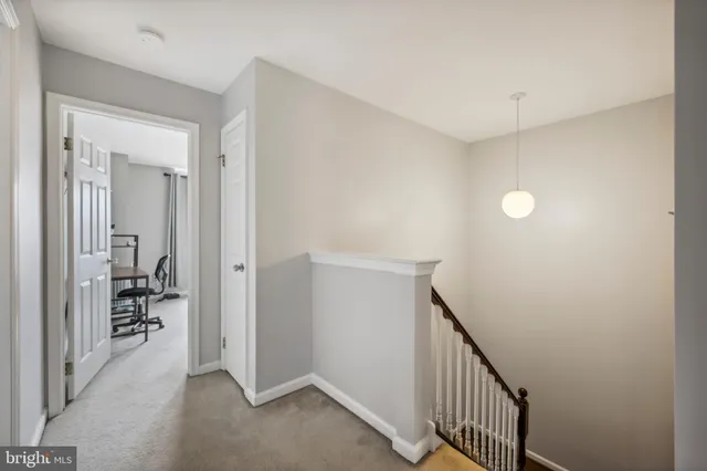 a view of a hallway with closet and a livingroom view