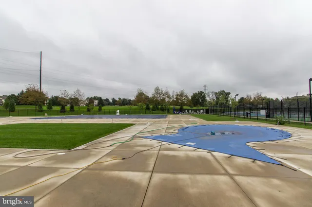 a view of a swimming pool and a yard