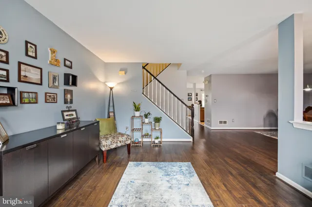 a view of entryway and hall with wooden floor