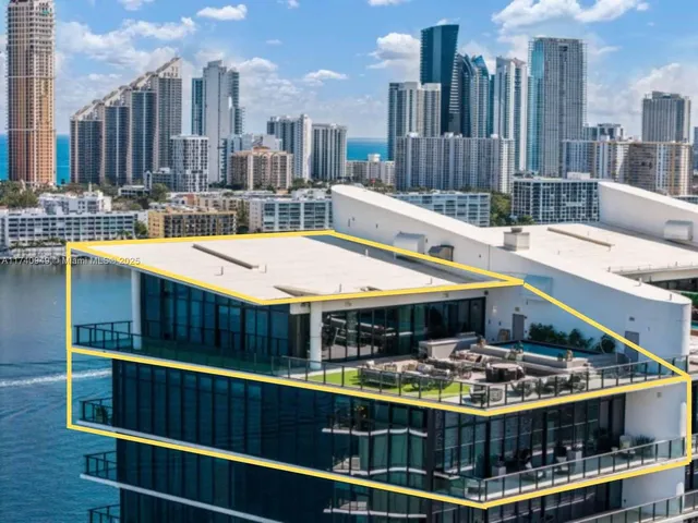 a living room with furniture and large windows