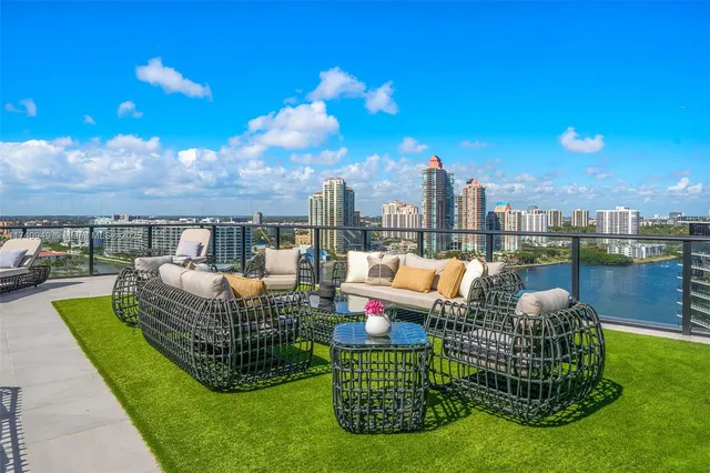 a kitchen with a sink a counter top space and a view of living room