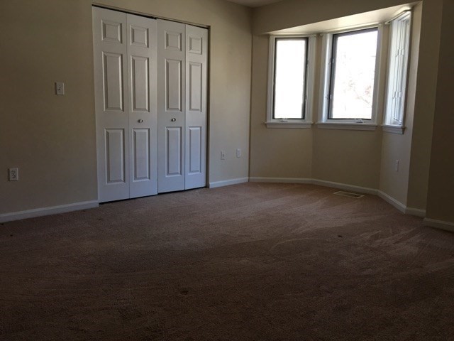 66 St James Street, Unit 209 Boston, MA 02119 - Photo 14 of 20 an empty room with windows