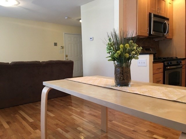 66 St James Street, Unit 209 Boston, MA 02119 - Photo 5 of 20 a vase of flowers sitting on a table