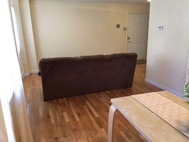 66 St James Street, Unit 209 Boston, MA 02119 - Photo 6 of 20 a bed sitting in a bedroom next to a window