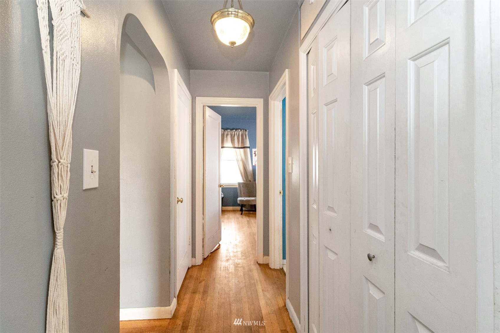 627 Madison Street Everett, WA 98203 - Photo 12 of 23 a view of a hallway with wooden floor and staircase