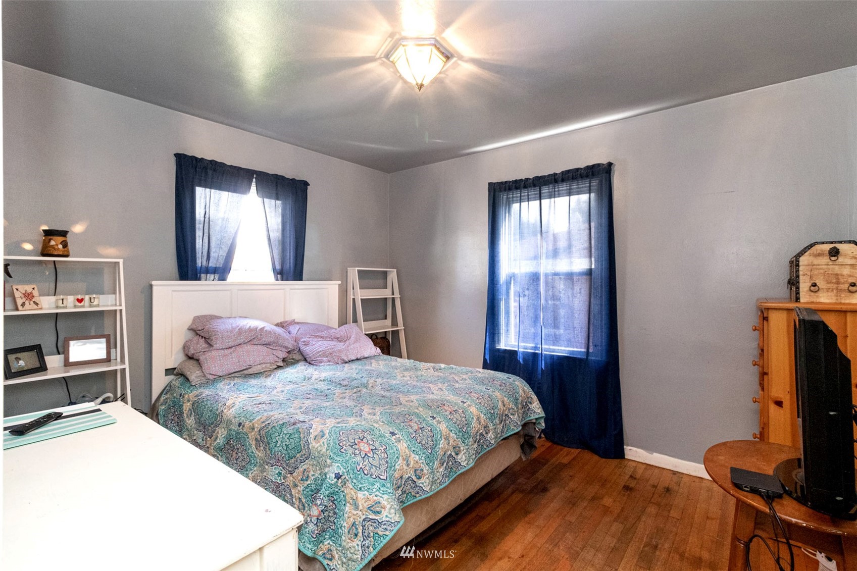 627 Madison Street Everett, WA 98203 - Photo 15 of 23 a bedroom with a bed and a flat screen tv