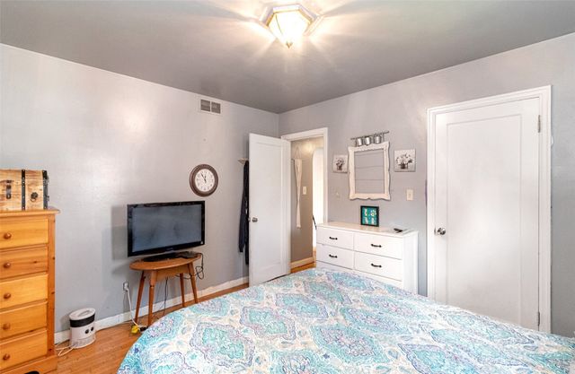 a bedroom with furniture and a flat screen tv