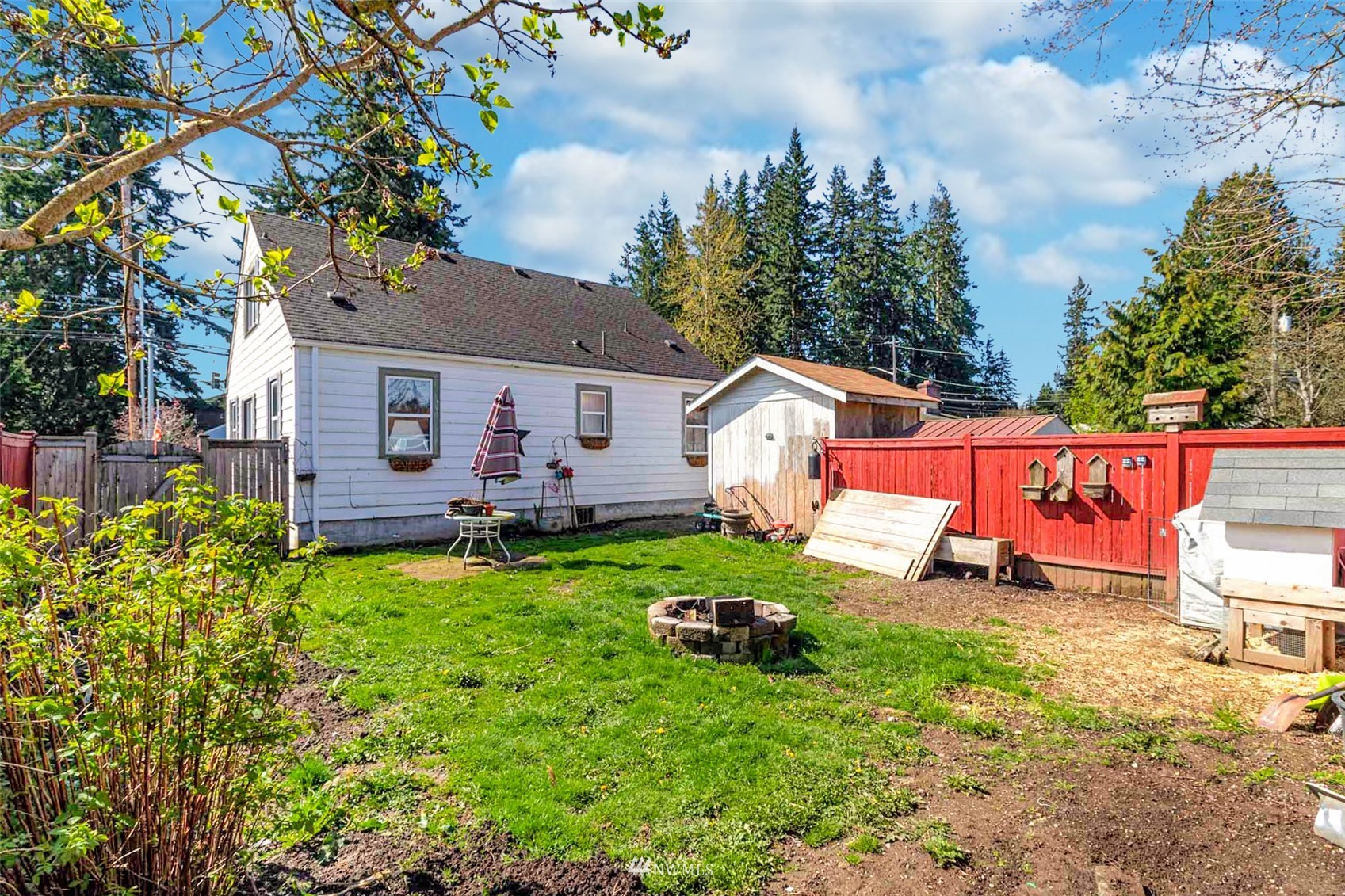 627 Madison Street Everett, WA 98203 - Photo 22 of 23 a view of a house with backyard sitting area and garden