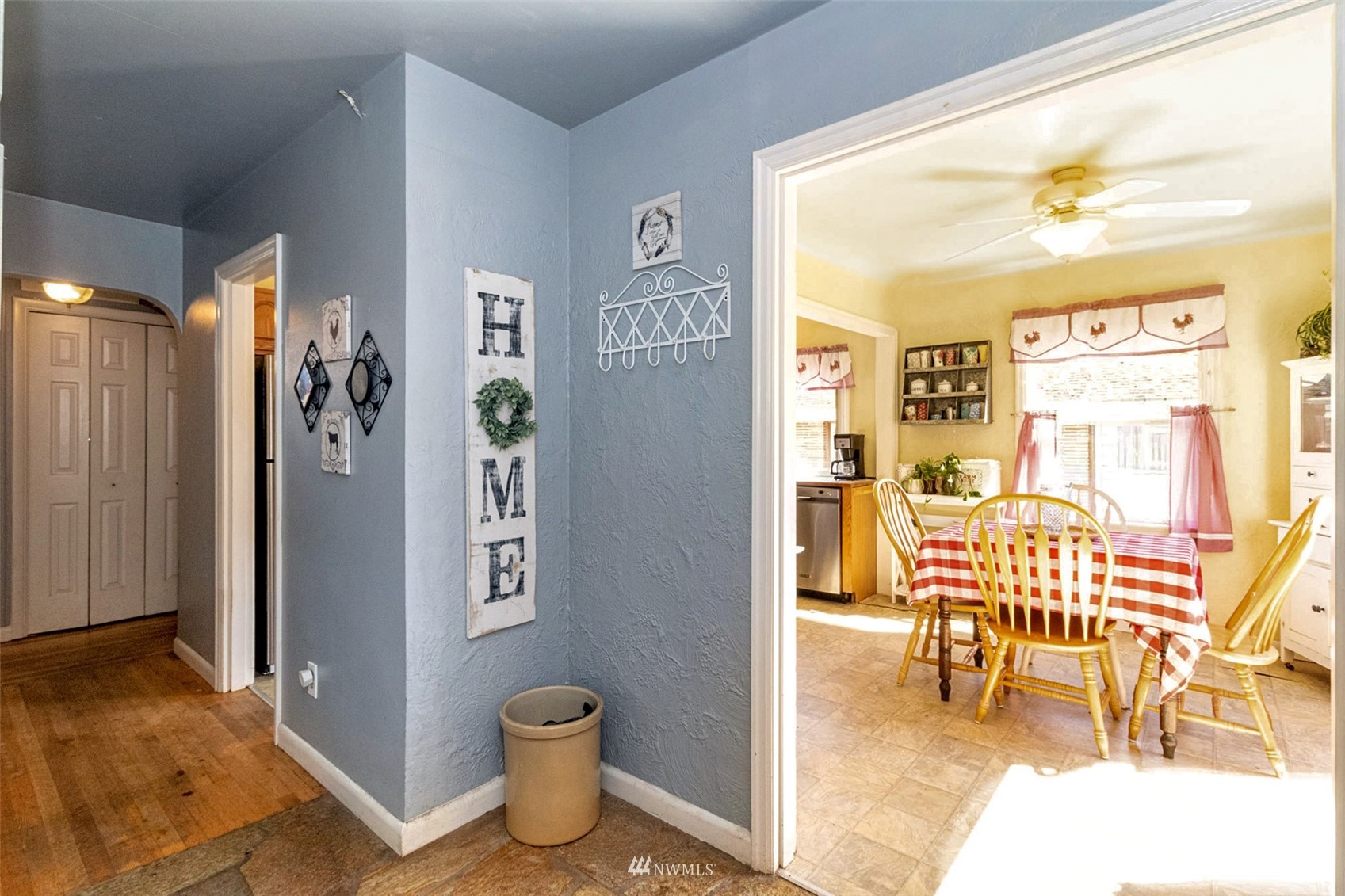 627 Madison Street Everett, WA 98203 - Photo 4 of 23 a living room with furniture a rug and a dining table with wooden floor