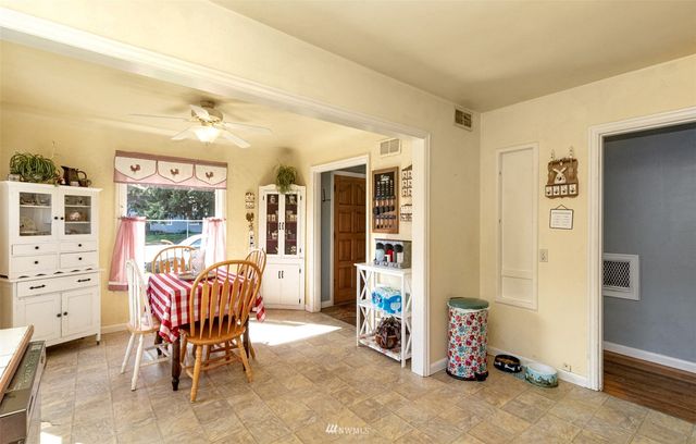 a dining room with furniture and a window