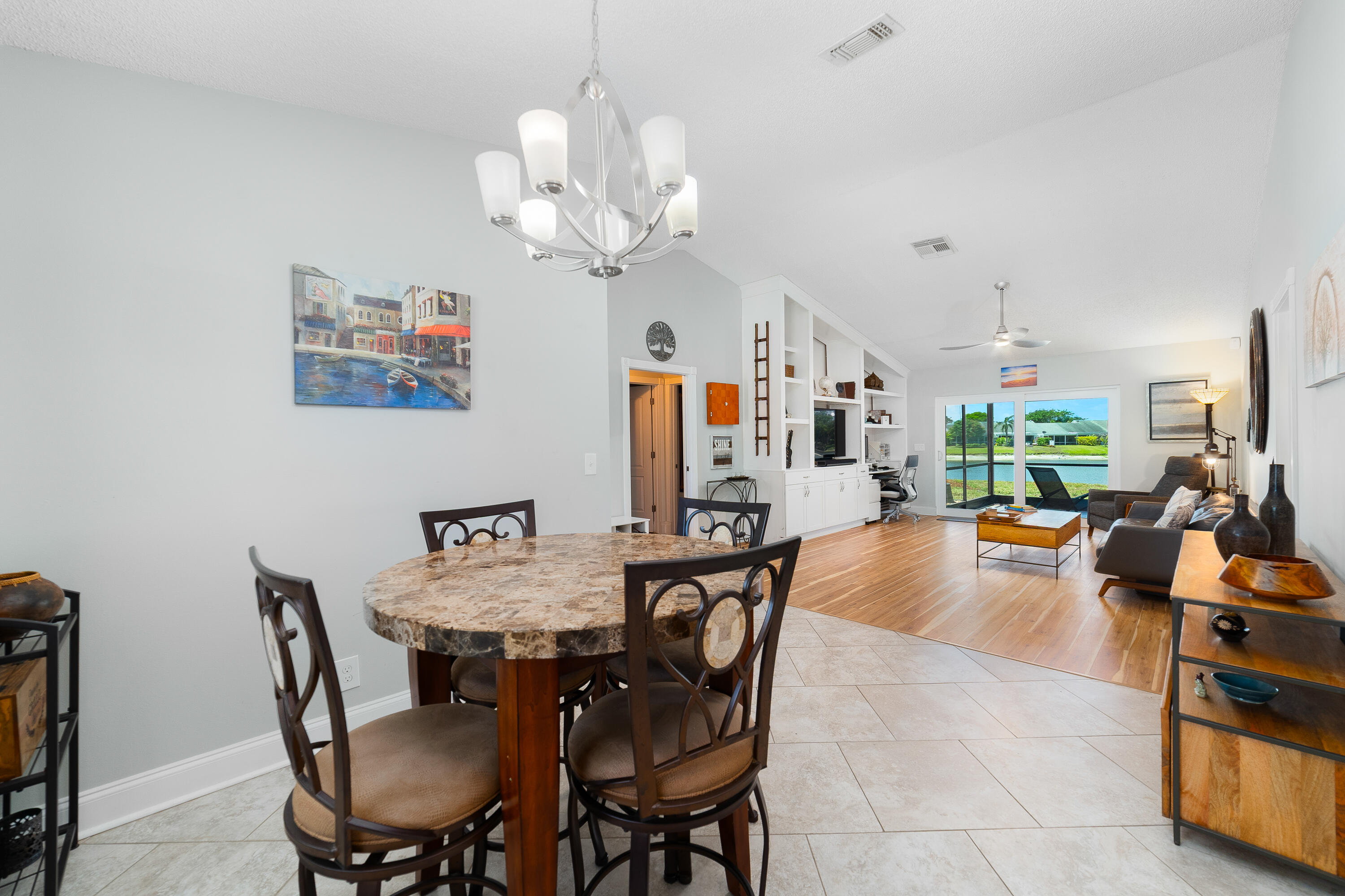142 Timberline Drive Jupiter, FL 33458 - Photo 12 of 35 a view of a dining room with furniture wooden floor and chandelier