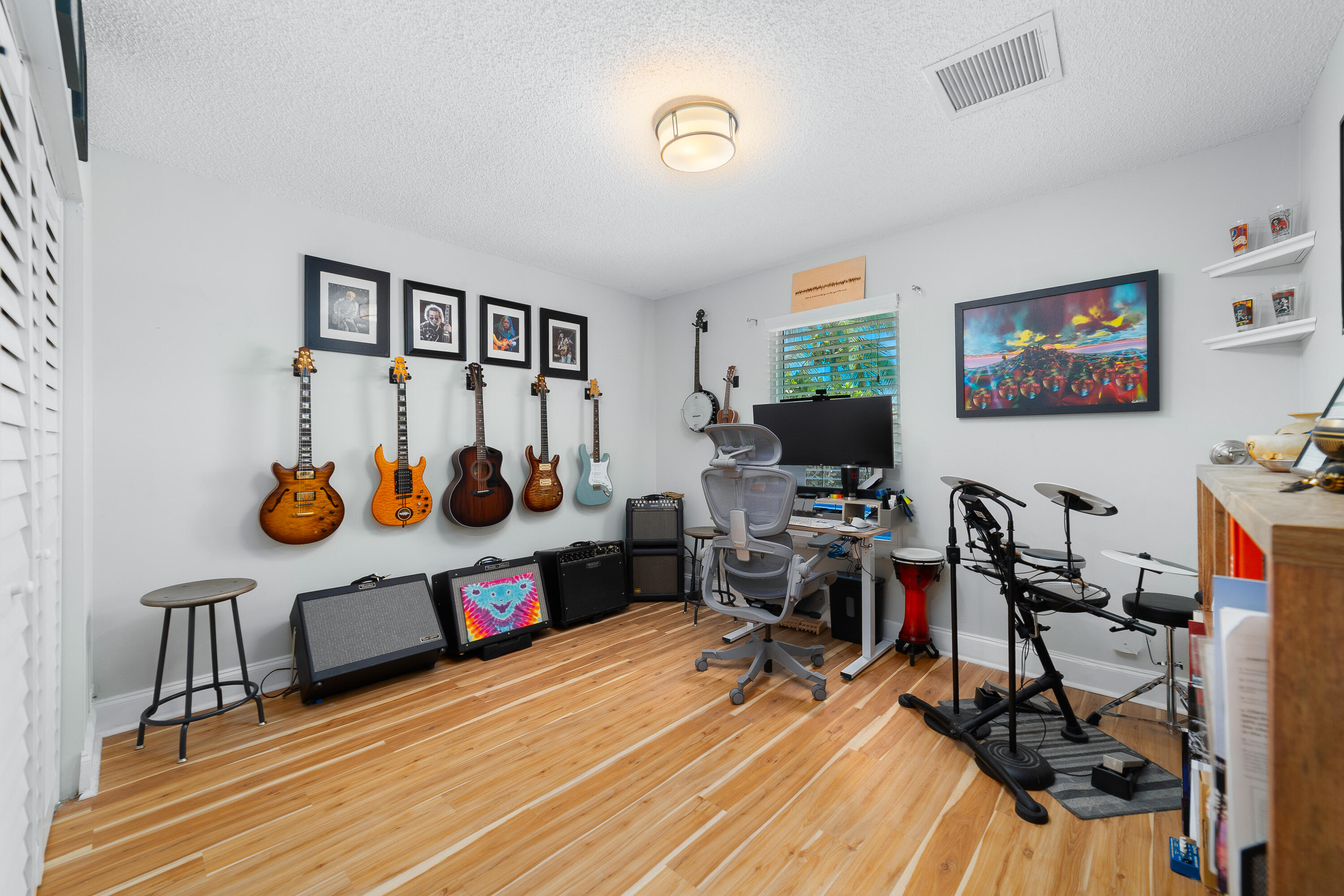 142 Timberline Drive Jupiter, FL 33458 - Photo 23 of 35 a view of a workspace with furniture and a flat screen tv