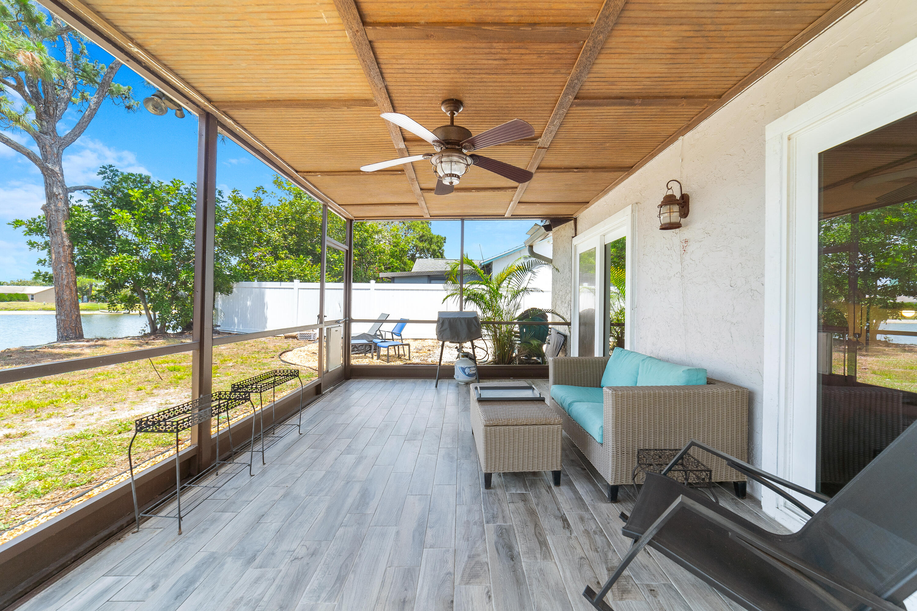 142 Timberline Drive Jupiter, FL 33458 - Photo 27 of 35 a view of a patio with a table chairs and a patio
