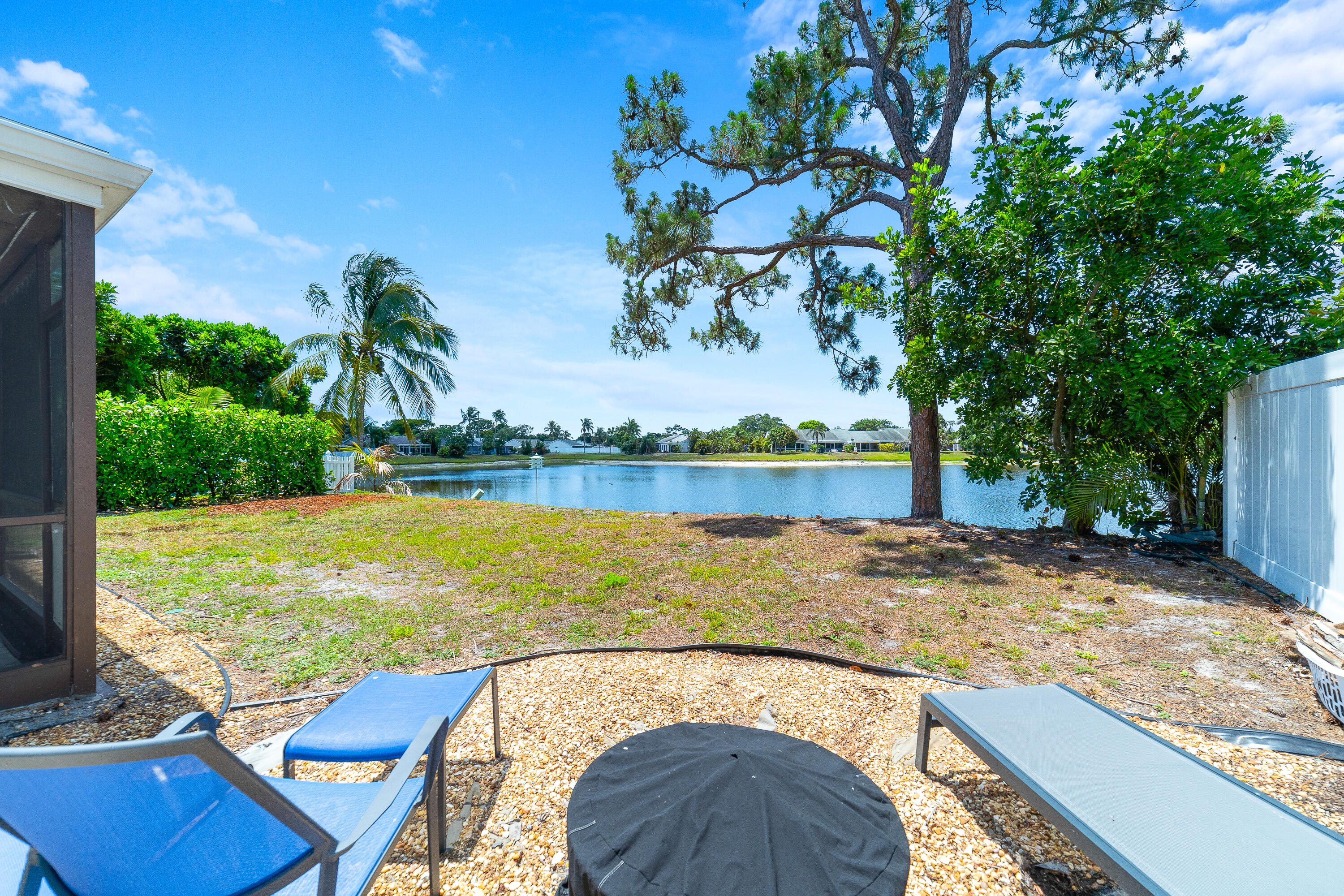 142 Timberline Drive Jupiter, FL 33458 - Photo 28 of 35 a view of a swimming pool with a patio and a yard