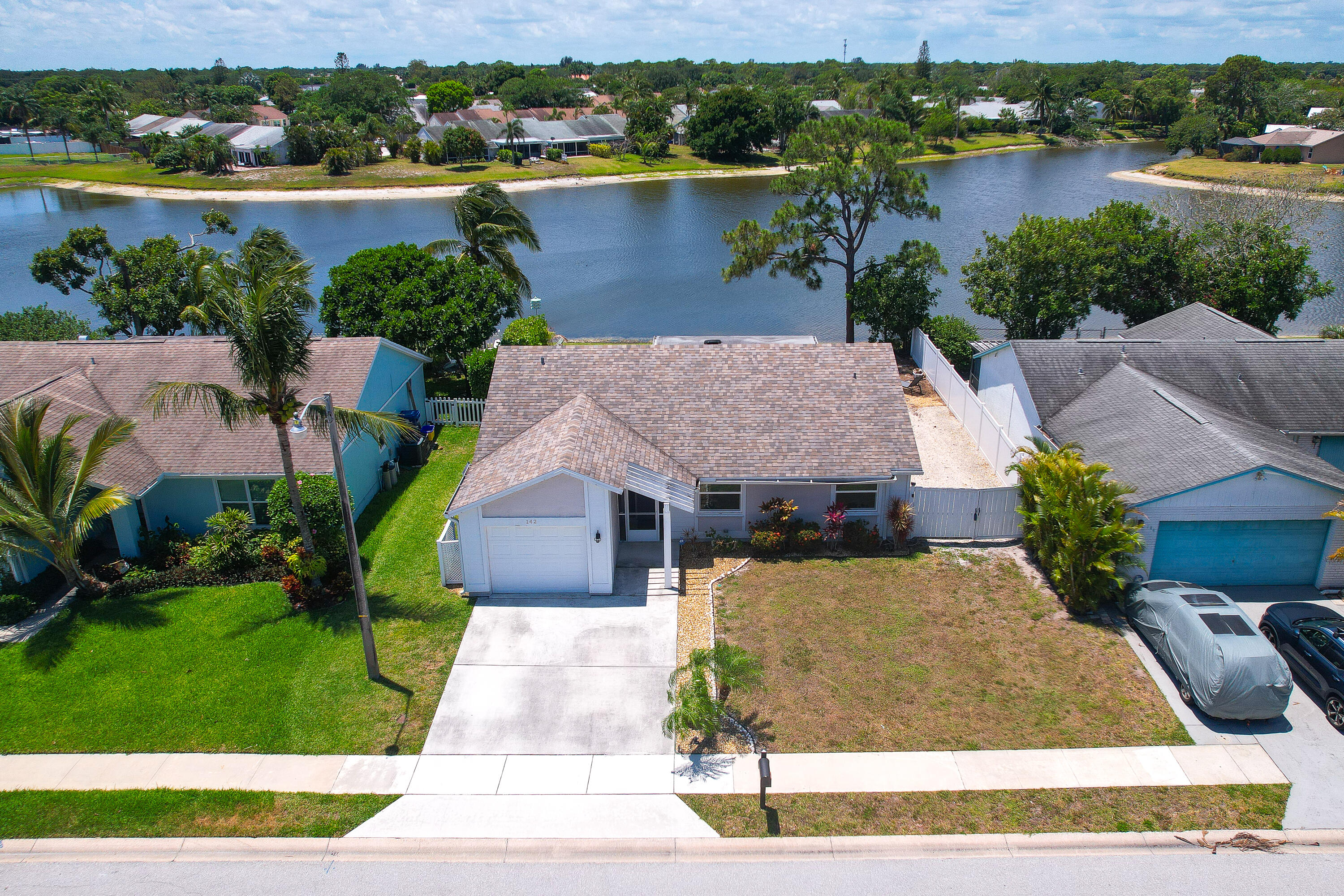 142 Timberline Drive Jupiter, FL 33458 - Photo 34 of 35 a aerial view of a house with a yard and lake view