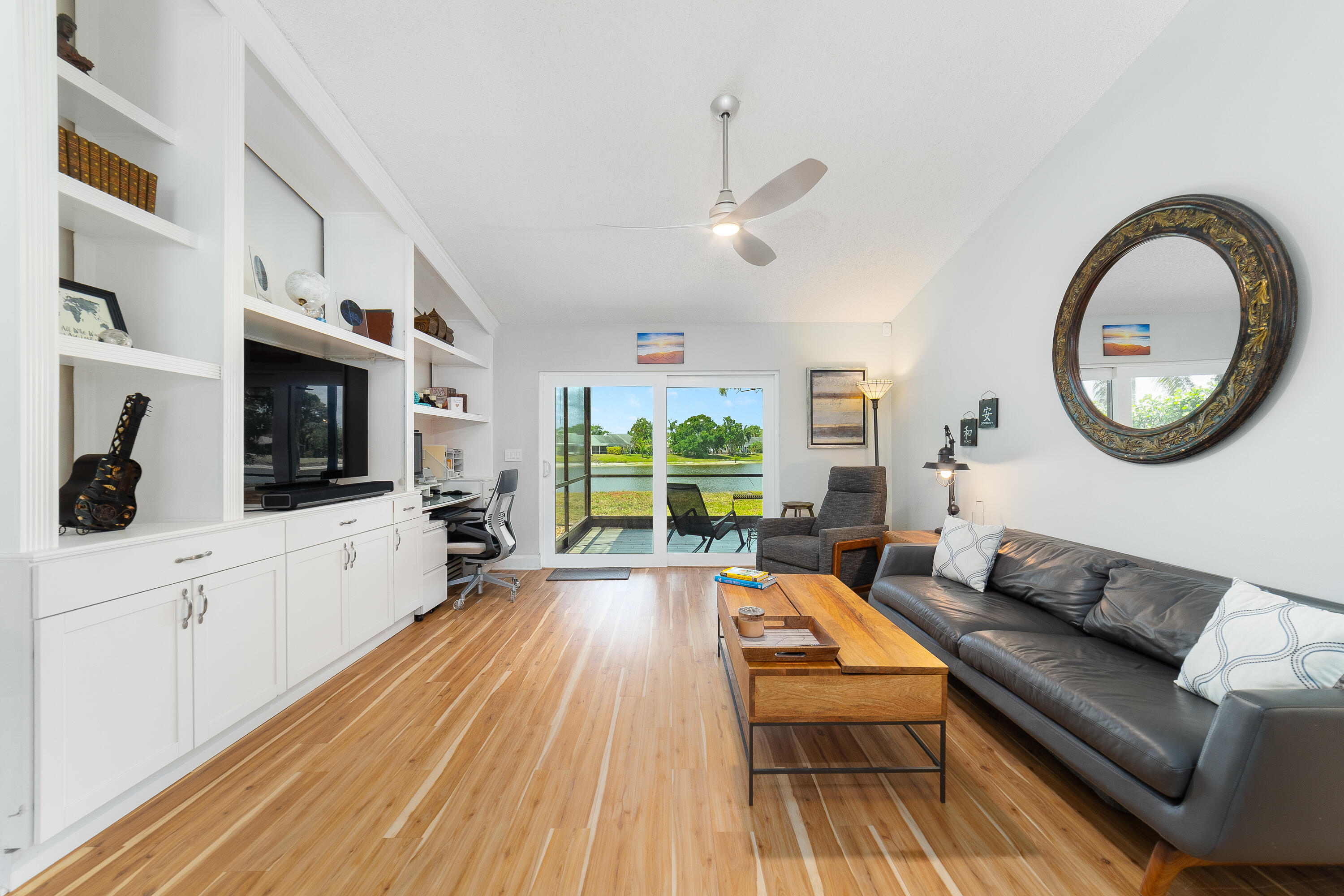 142 Timberline Drive Jupiter, FL 33458 - Photo 6 of 35 a living room with furniture a flat screen tv and a large window