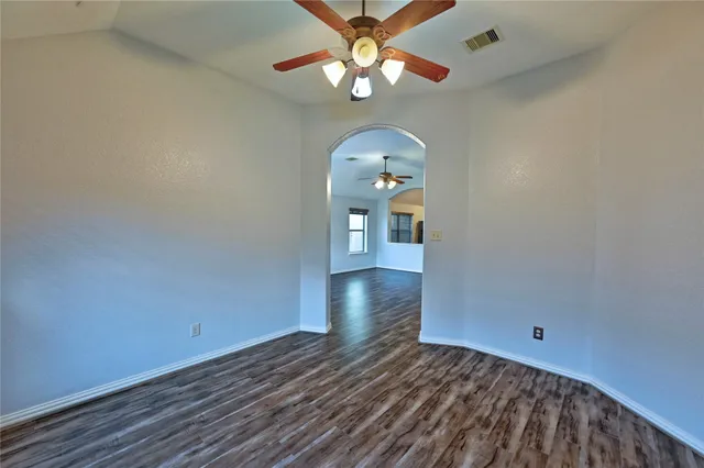 a bathroom with a granite countertop sink a mirror and shower