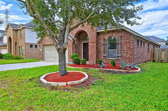 a front view of a house with swimming pool and yard
